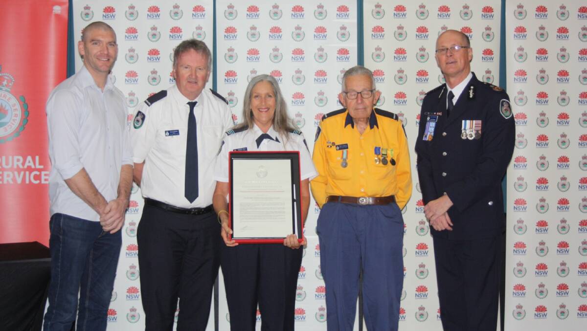 RFS Deputy Commissioner Kyle Stewart APM and Eurobodalla Shire Mayor Matthew Hatcher present Captain Danielle Brice, President Gerard Simms and past President Peter Anderson with a Commissioners Certificate of Commendation for the Eurobodalla Volunteer Operations Support Brigade.
