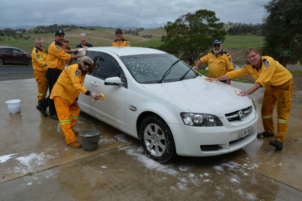 DOUSED: Members of the Buckajo Rural Fire Service turn their hands, and hoses, to washing cars for their annual brigade fundraiser.