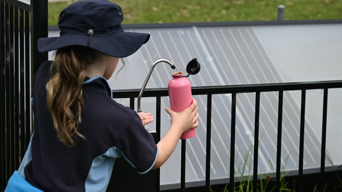 Schoolchildren at Cobargo refill their drink bottles each day using the 10 panels donated to the school following the 2019/20 bushfires.Photo: Supplied