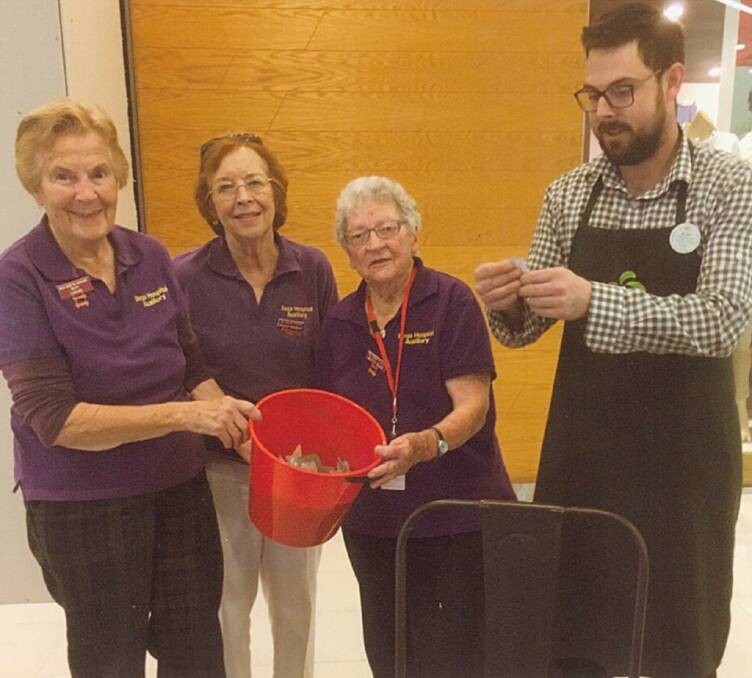 Todd Harnett from Woolworths draws the Bega Hospital Auxiliary Easter raffle with auxiliary members Betty Lovelock, Gillian Wildman and Betty Rose.