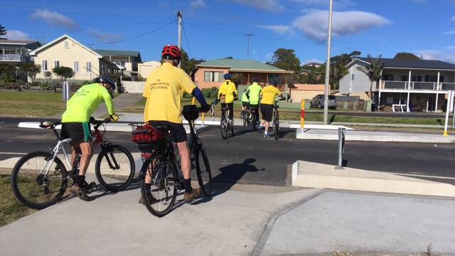 Cyclists from the bicycle division of the Bermagui Institute use the newly constructed pedestrian/cyclist refuge across Lamont Street, Bermagui.