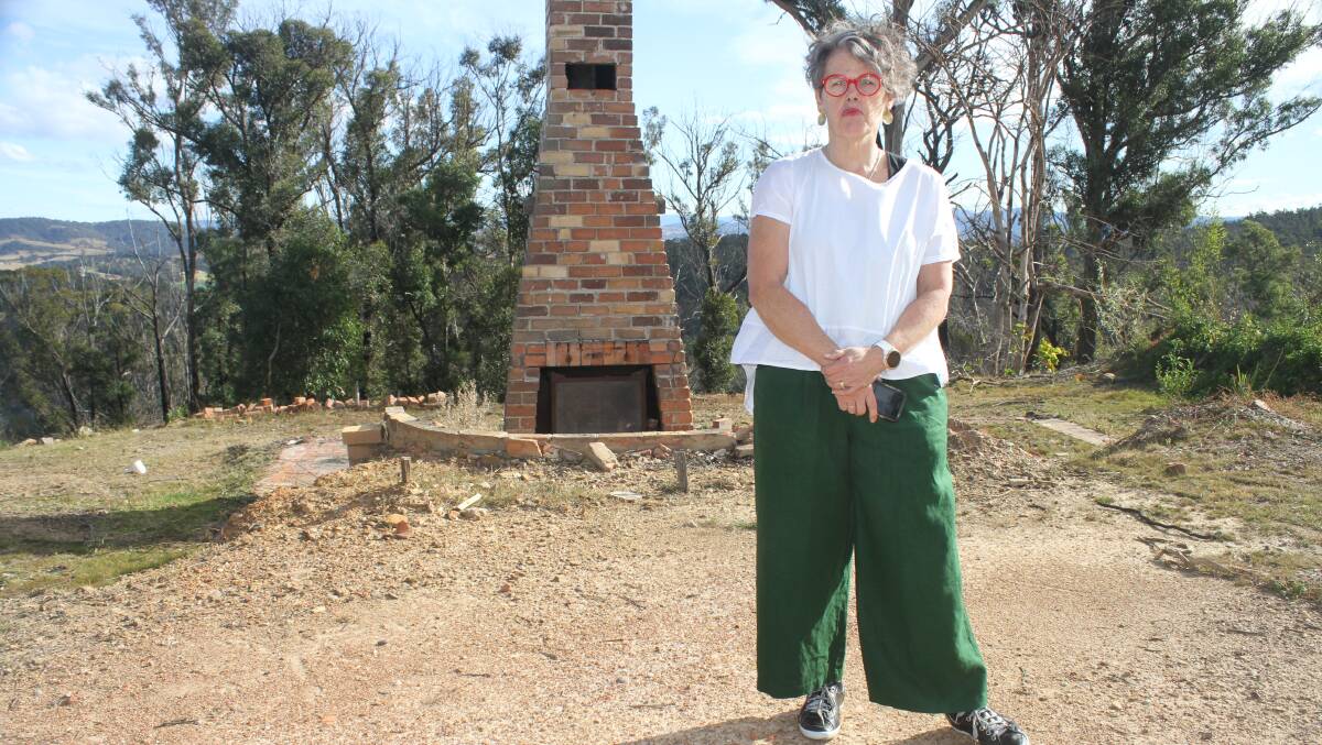 Jan Harris stand in the remains of her property, two years after the Tathra and District bushfire. This week marks three years since the devastating blaze.