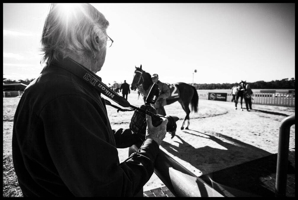 Richard Wiles photographs the horses and jockeys before a race on Eden Cup Day. He also captures each photo finish. Photo: Rachel Mounsey