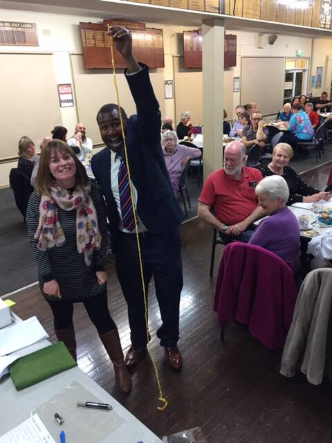 STEADY HANDS: Guest quiz master Daniel Doody admires and measures Kate Hanlon's orange peel at the Friends of the Old Bega Hospital's trivia night.
