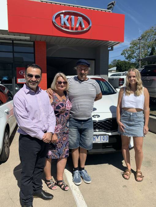 GRATEFUL: Carol Nelson, her partner Paul Parthenides and Elyssa Nelson take delivery of their new Kia from John Stylianou at Tarra.