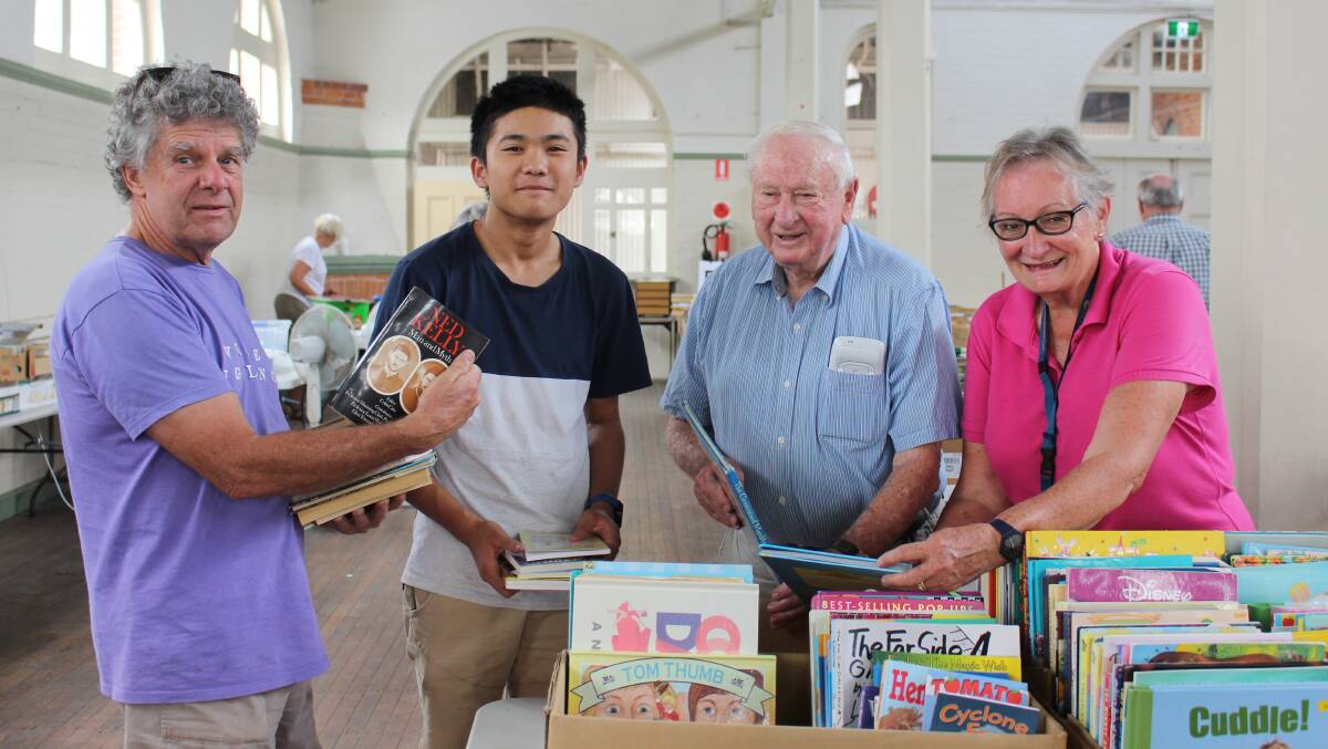 SETTING UP: Jock Moase, Nathan Njuyen, Paul Windle and Marg Taylor help set up the pavilio-full of second-hand books for the weekend's Rotary Book Fair.
