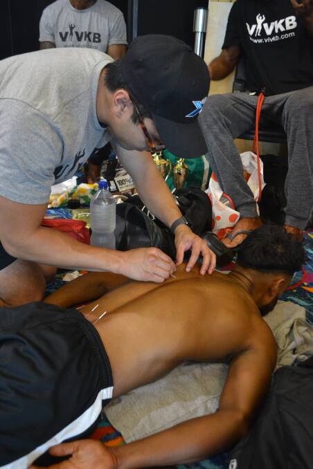Athlete Omar Abdalslam undergoes dry needling before his competition to help increase blood flow in the muscle area. 