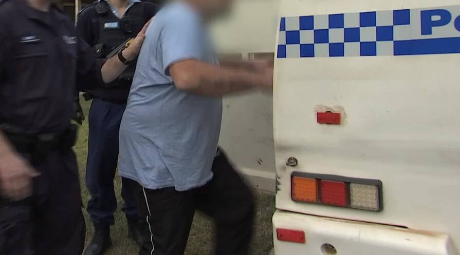 Police arresting a man at Surf Beach following an investigation. Image: NSW Police.