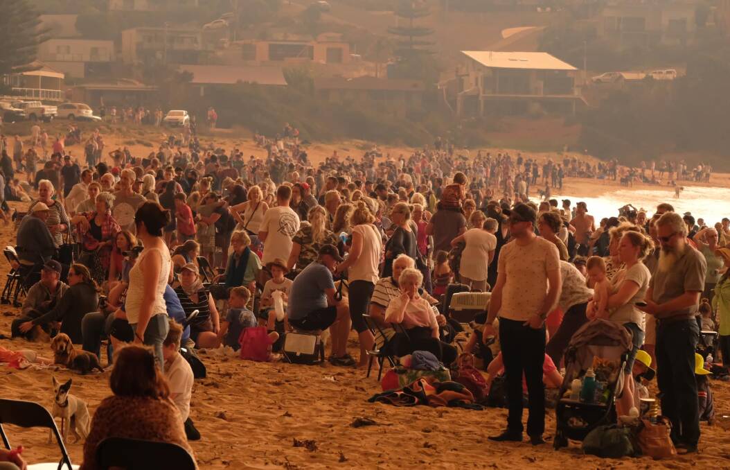 NEW YEAR'S EVE: Evacuees pack Malua Bay beach as bushfires ravaged the coast on New Year's Eve. Image: Alex Coppel