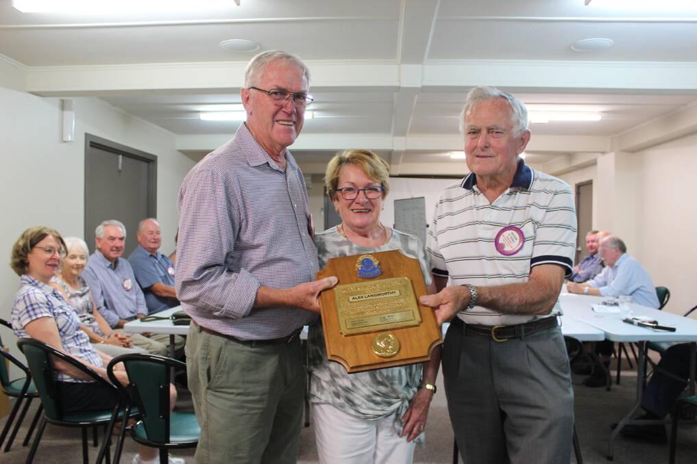 AWARDED: Alex Langworthy accepts the Melvin Jones Fellowship with wife Ros at the Bega Lions meeting from Bega Lions president Peter Wiley.