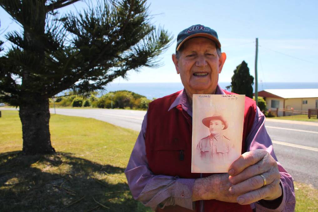 STRIKING SIMILARITIES Tathra's Allen Collins with a photo of his uncle,George Golbourn Warren, who served in World War I. Picture: Alana Beitz