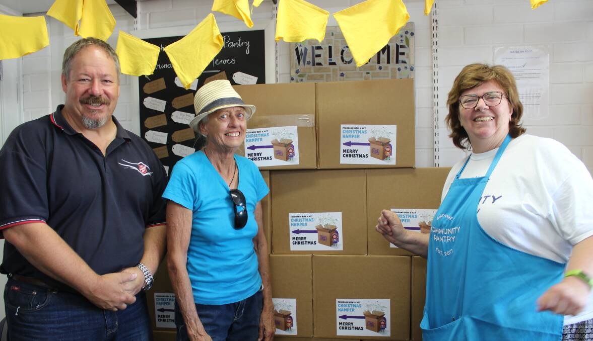 Salvation Army Lieutenant Rod Parsons and Southern Women's Group treasurer Wendy Hunter thank Christine Welsh for the Food Bank hampers provided through the Sapphire Community Pantry. 