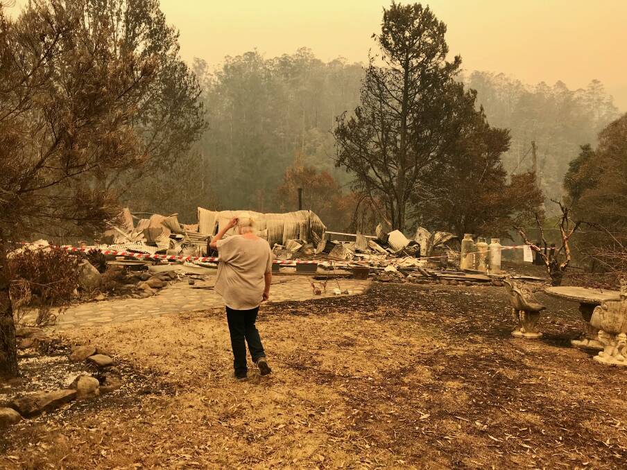 SURVEYING THE WRECKAGE: Suzie West lost her home in the Upper Pappinbarra bushfire in November. BlazeAid is helping her rebuild. Photo supplied.