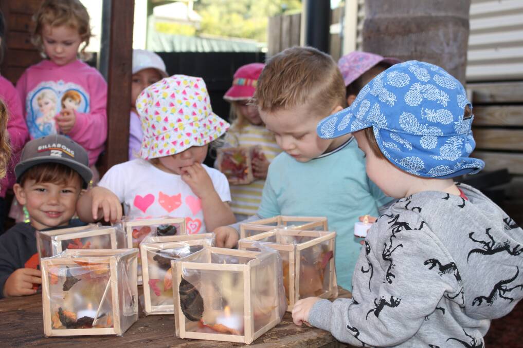 HELPING HANDS: Concentration is needed as each lantern gets an LED at Pambula Village Preschool.