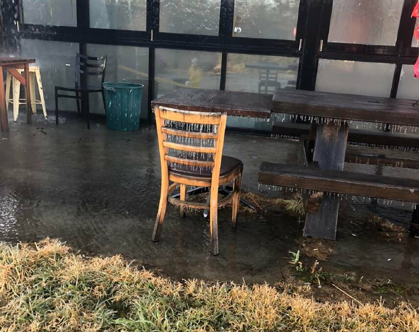 Cold enough to freeze the spray off a firies hose. Icicles formed on chairs and table edges after being dowsed with spray. Photo: Eden FRNSW