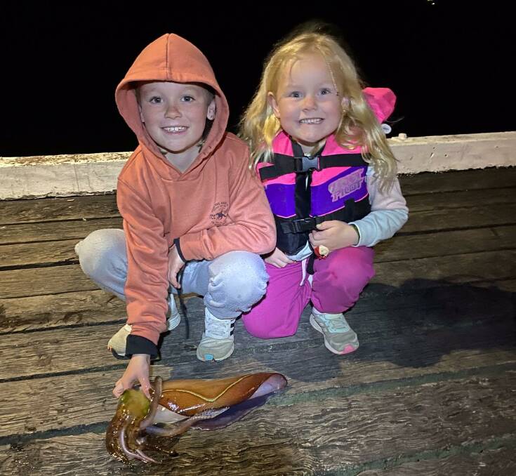 Lachlan Wilkin's magnificent 44cm Calamari Squid shown on the Merimbula Wharf together with his sister Olivia, while on school holidays from Bairnsdale.