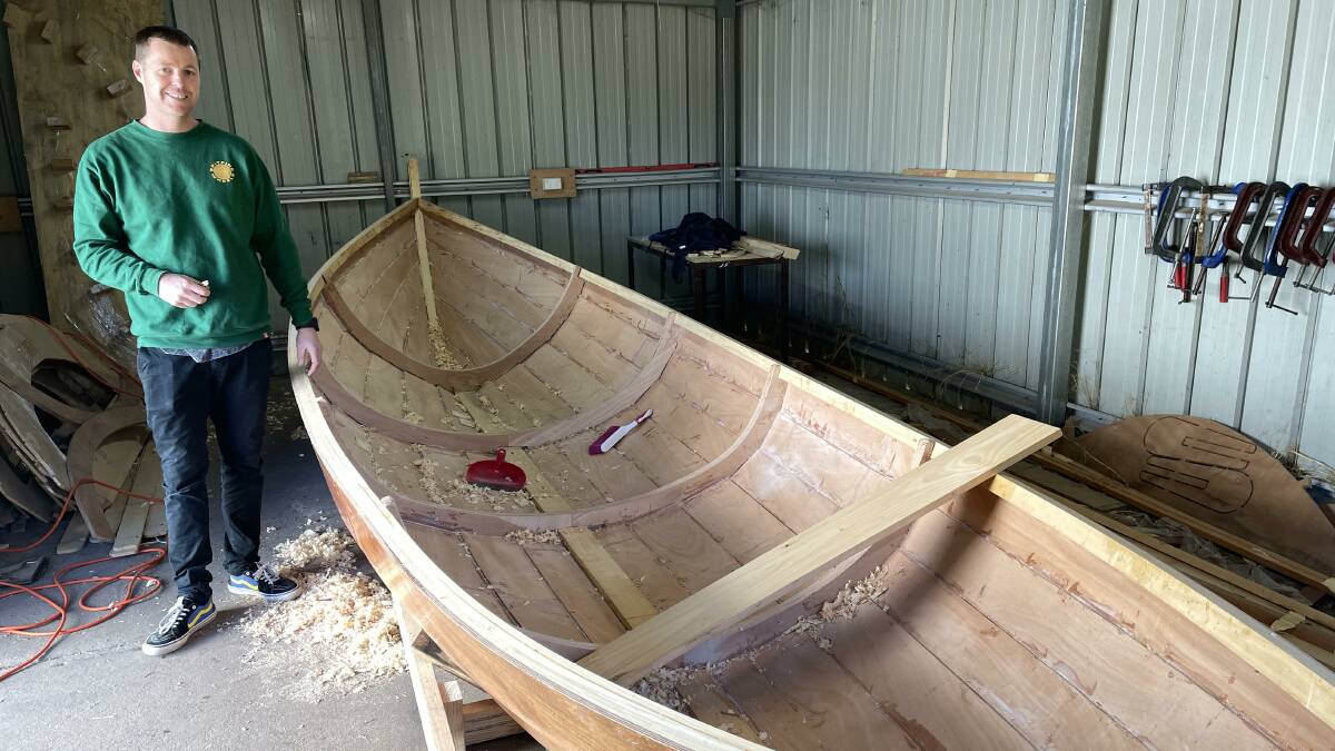 Eden Marine High School teacher Brendon Richards with a whale boat made by students. Picture by Denise Dion 