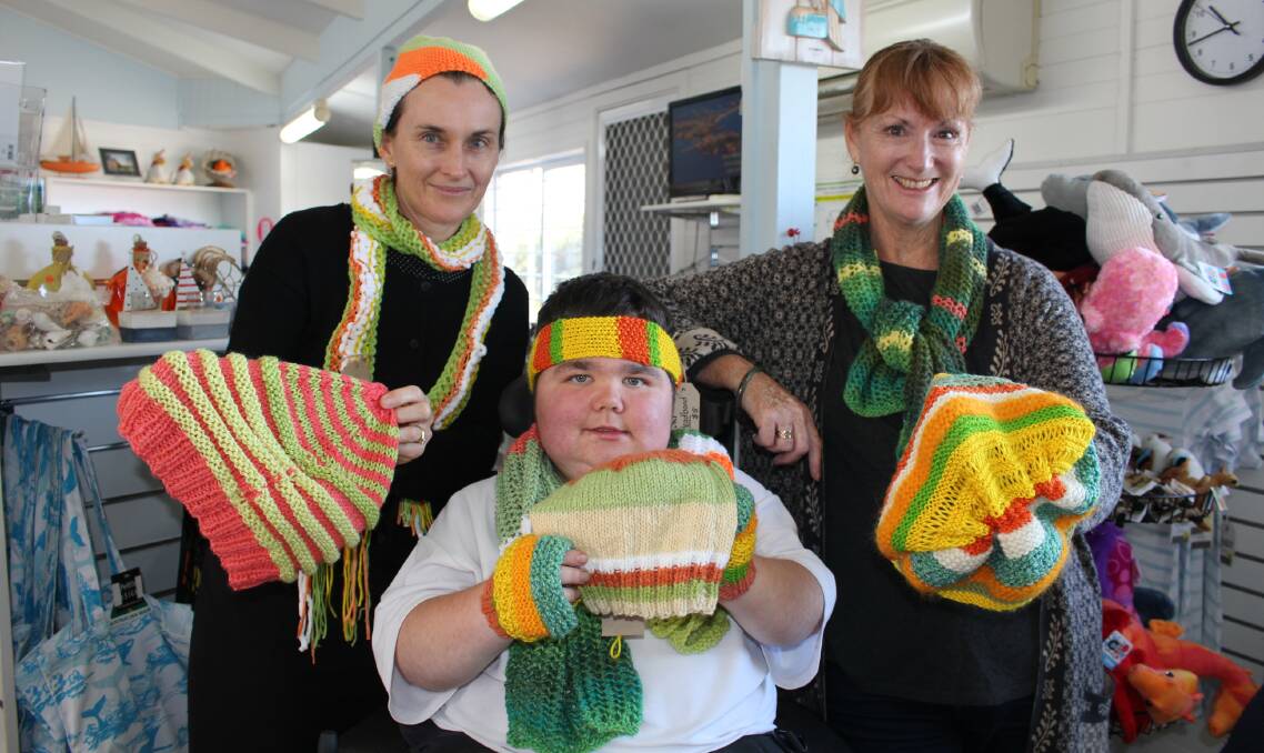 WARM THOUGHTS: Ginny Francis, Lachlan Thomson and Liz Smallwood at the Merimbula Visitor Information Centre, with the jazz beanies.