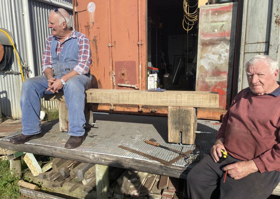 Eden Men's Shed members Geoff Sims and Ian English take a break between working on the benches. Picture supplied