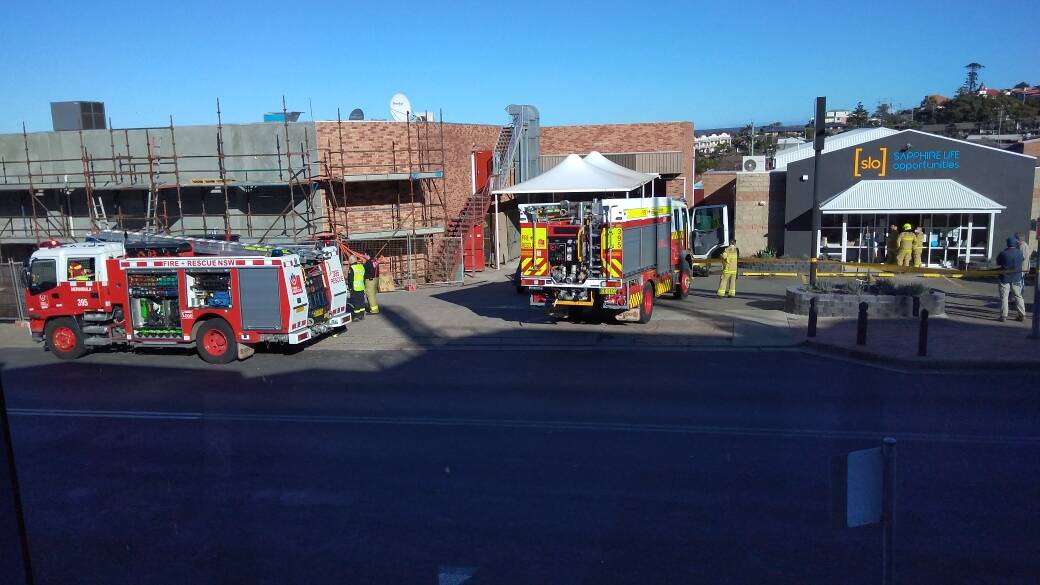 Fire and Rescue NSW crews outside the old Woolworths building on Monday afternoon.