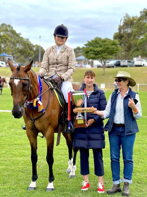 Shari Grist of Pambula and Spinner (Kyhan Seventh Heaven) who won the Jan High Memorial Trophy presented by Chris Billing of the Sapphire Coast Trail Riders with judge Jane Mitchell. 