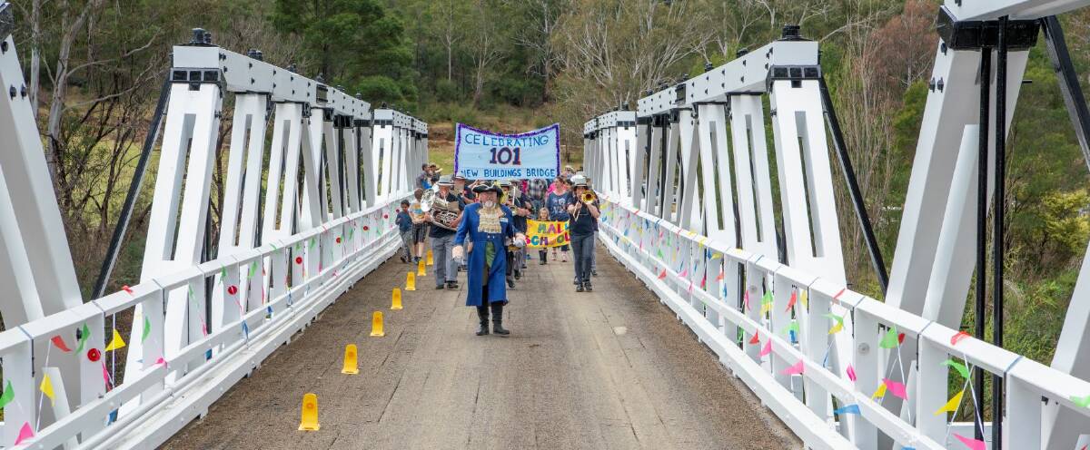 The community led by the town crier make their way across the bridge. Picture by Brent Occleshaw