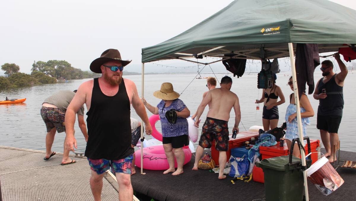 Action stations as Mikey Jacob, family and friends, pull alongside the boat ramp jetty near the Merimbula causeway, for a pit stop. 