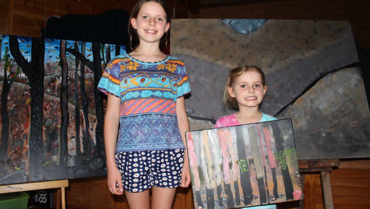 Sisters Arlie and Ottilie Richardson with their bushfire influenced art which was on display at the Towamba meeting.