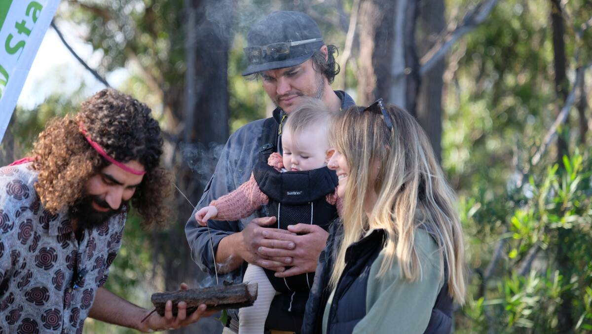 Creative Lines director Yully Forest with wife Erin and daughter Kora during the Smoking Ceremony performed by Twofold Aboriginal Corporations Nathan Lygon at the start of work on the Eden mountain bike trail.