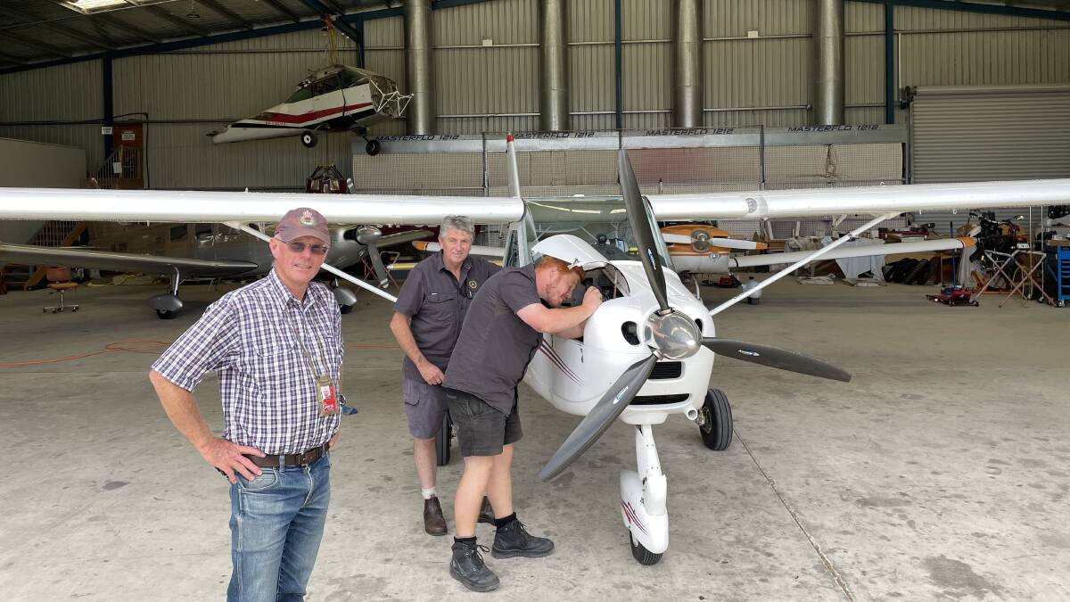 Peter Davis at the Merimbula Aircraft Maintenance hangar with owner Rex Koerbin and apprentice Tom Burn. Picture by Denise Dion
