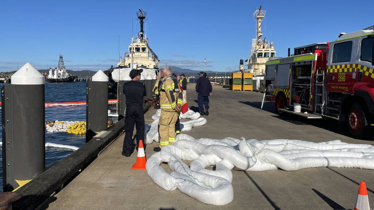 Fire & Rescue NSW deployed white and orange booms to soak up and contain any pollution occurring from the Janet, the trawler that sank next to Eden's Middle Wharf.