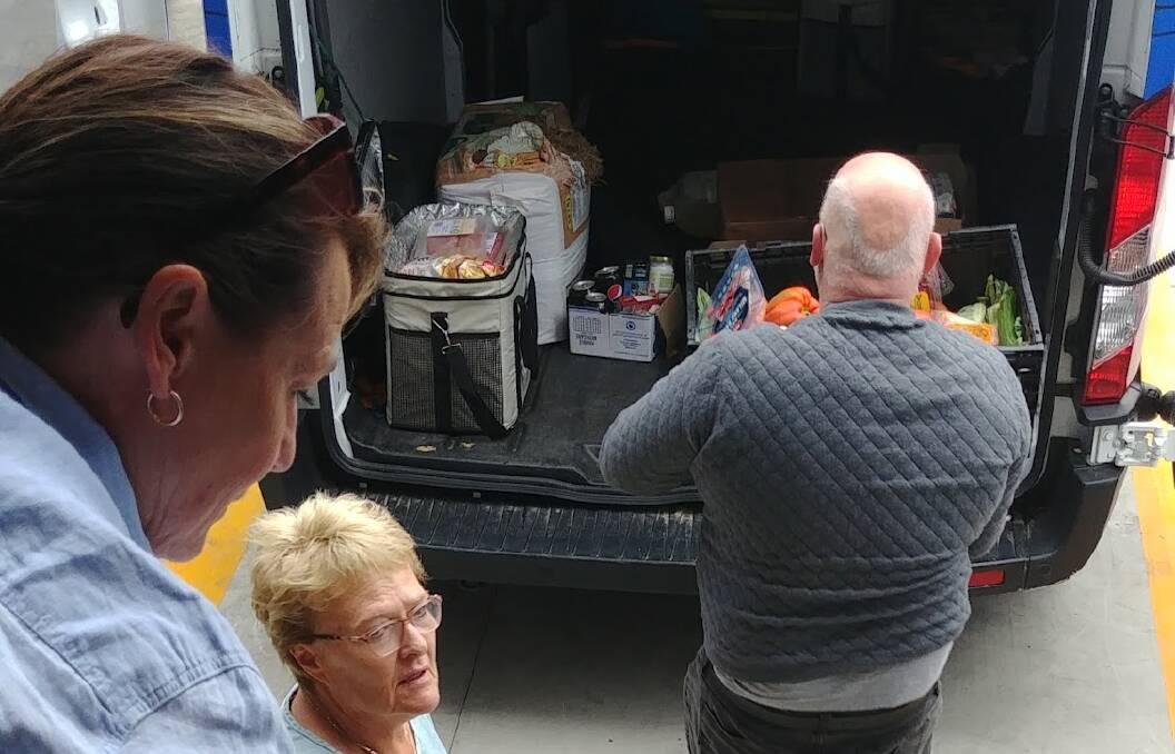 Organising the donated food from Aldi into the van for transport to the Sapphire Community Pantry.