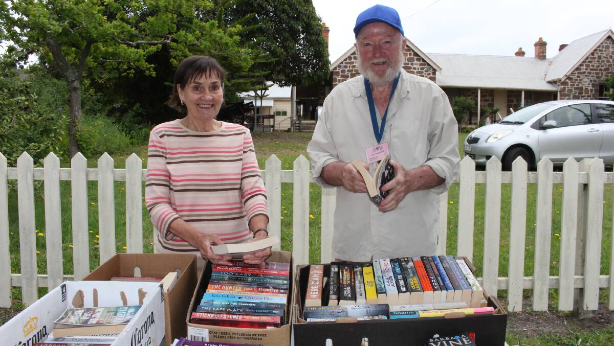 Museum curator Liz Bretherton and president Don Bretherton at one of the book stalls on Saturday. Photo Denise Dion