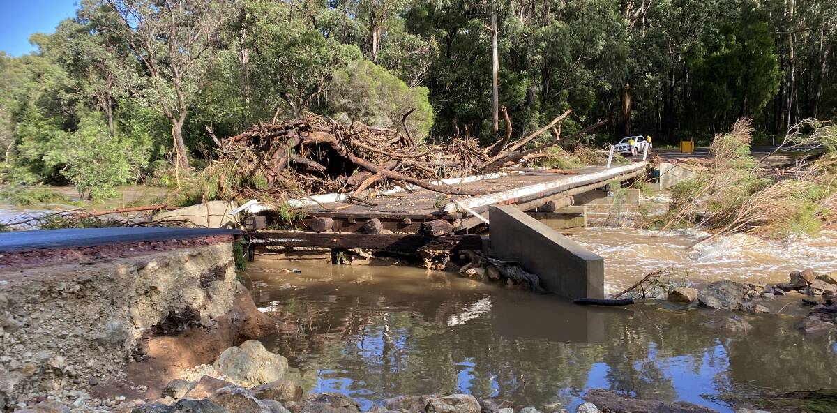 The devastated bridge on Nethercote Road over the Yowaka River on Wednesday morning showing the large build up of debris that contributed to the bridge's demise.
