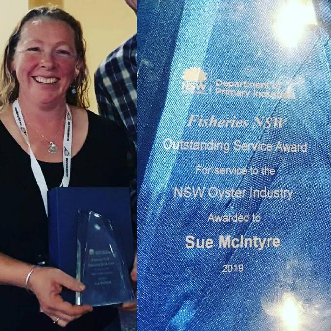 Sue McIntyre of Broadwater Oysters holds her Outstanding Service Award for service to NSW Oyster Industry. Photo: Supplied