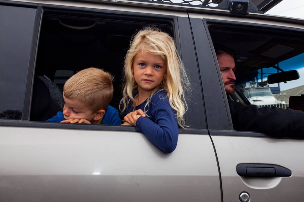 Kids watch the march from their car. Photo: Rachel Mounsey