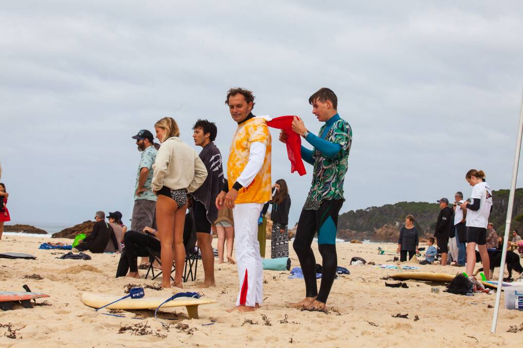 The King hits the surf: Brett Menke aka Elvis gets his cape prepared for the swell. Photo: Rachel Mounsey
