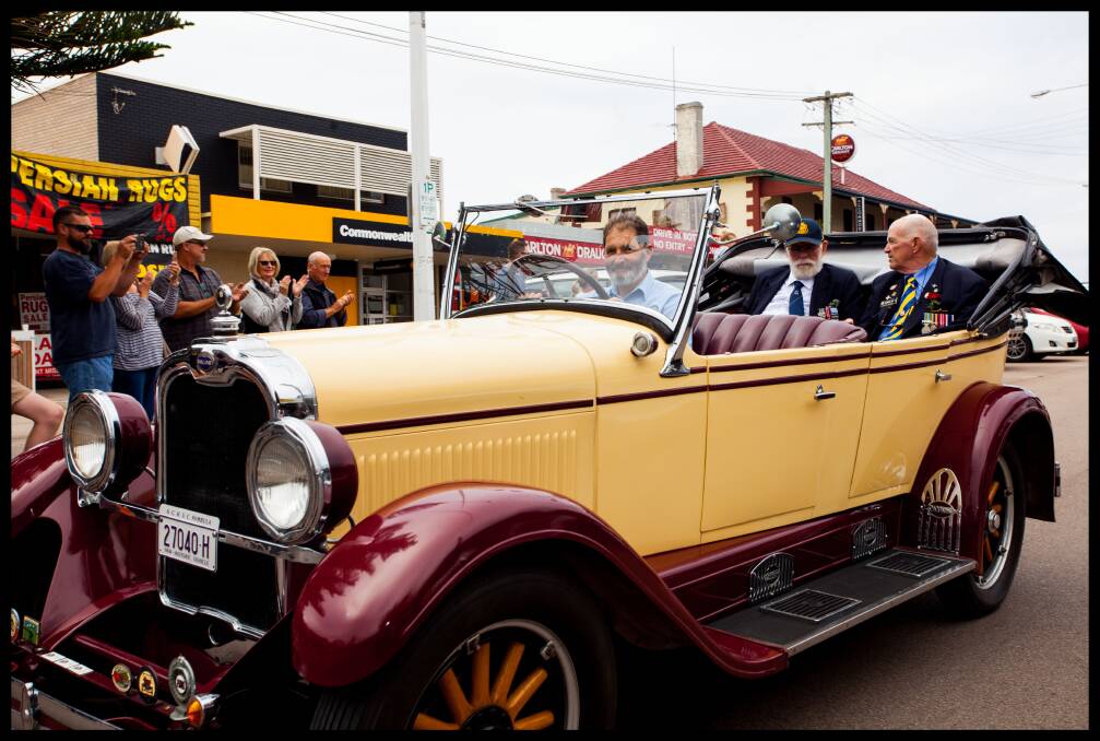 Anzac Day 2019: Fred Silk chauffeurs Eden veterans Barry Beck and Peter Rice through the Imlay Street parade. Photo: Rachel Mounsey