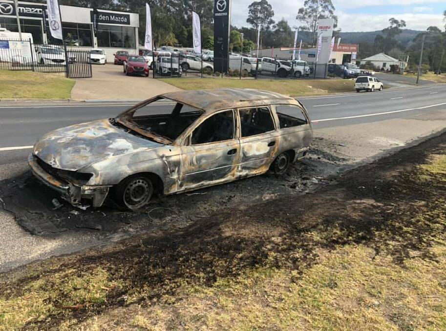 Police are investigating a burnt out station wagon set alight on Princes Highway in Eden overnight. Photo: Fire and Rescue NSW