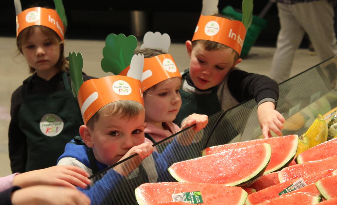 HEALTHY HABITS: Children at Bega Preschool examine fresh fruit as part of the Woolworths Fresh Food Discovery Tour.