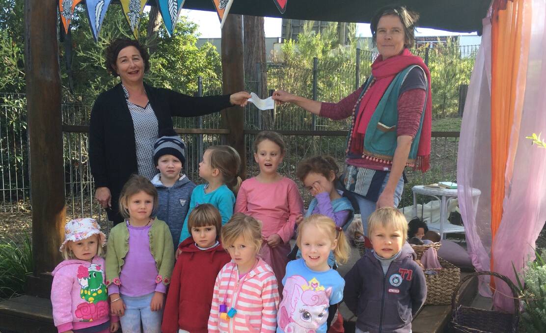 REAPING THE BENEFITS: Kylie Dummer from the Wharf to Waves Committee presents a cheque for $7000 to Jane Courtney at Tathra Preschool. 