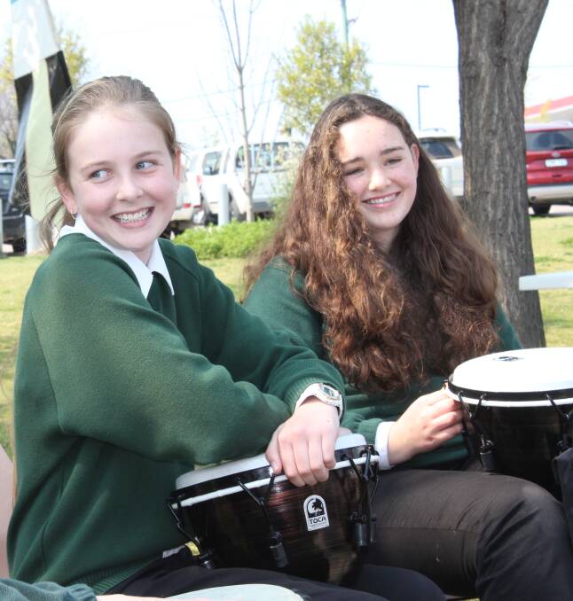 FEELING THE BEAT: Year 7 students at the Sapphire Coast Anglican College Amy De Friskbom and Grace Burns take part in the DRUMBEAT program in Littleton Gardens on September 14.