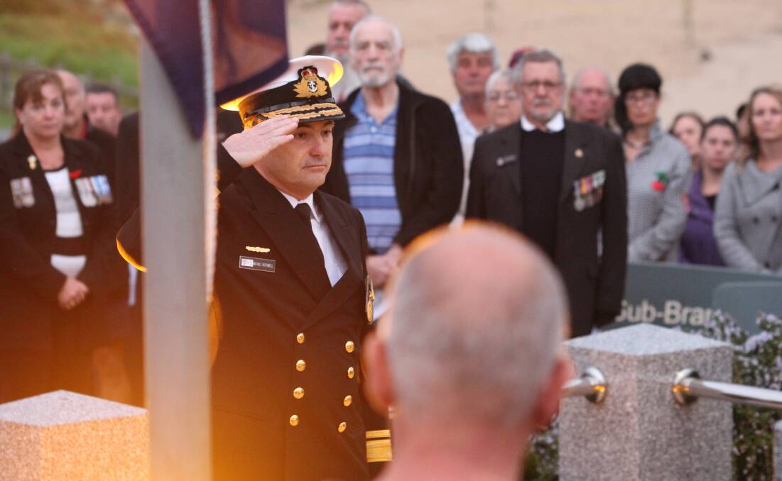 Michael Rothwell salutes the war memorial during Bermagui's Anzac Day dawn service. Picture: Albert McKnight