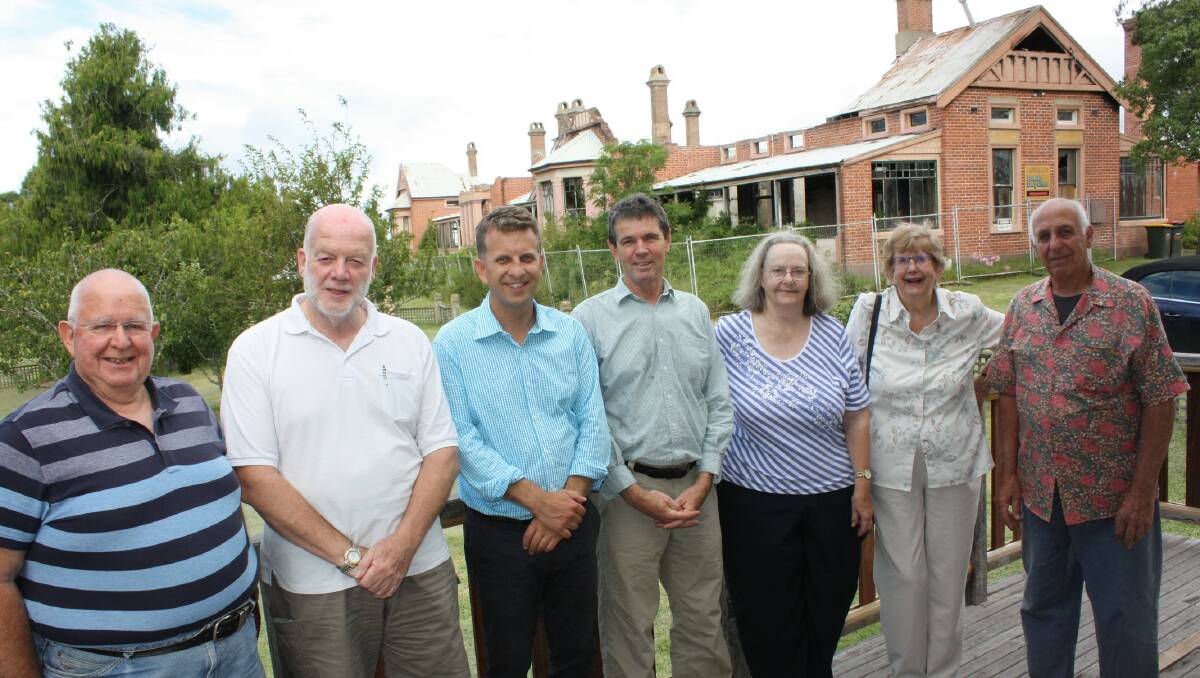 In 2015, Member for Bega Andrew Constance meets with Friends of the Old Bega Hospital members (from left) John Reynolds, Eric Myers, Richard Bomford, Pat Jones, Claire Lupton and Jay Ellard.