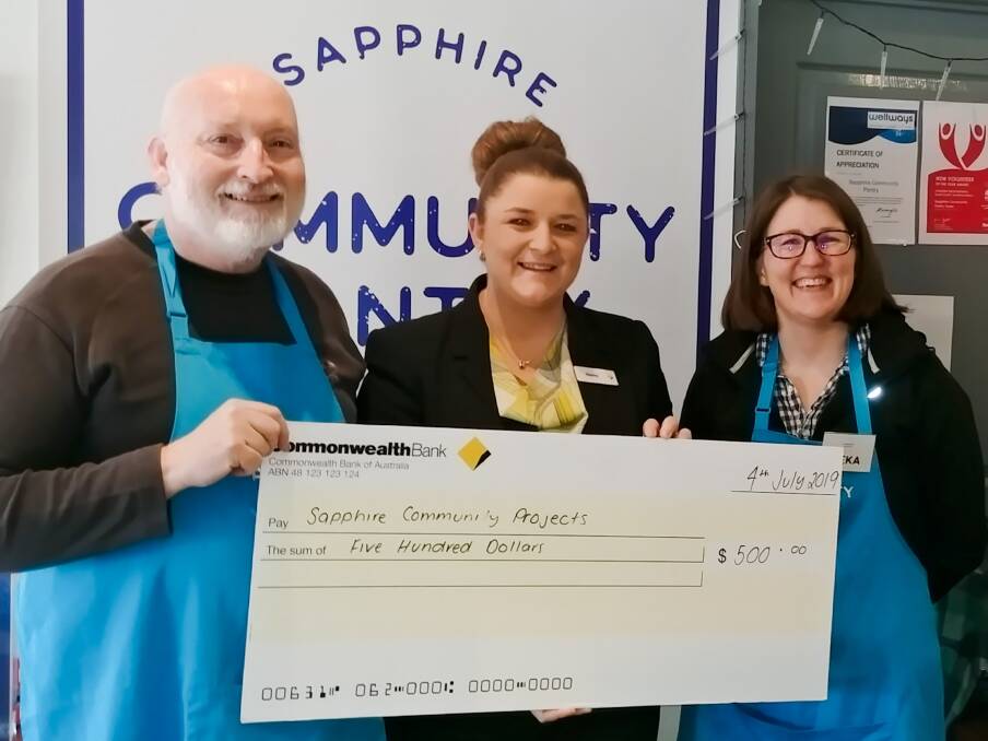 BIG SMILES: Secretary of Sapphire Community Projects Inc Peter Buggy, savings specialist at the Commonwealth Bank Bega Hayley James and coordinator of the Sapphire Community Pantry Reka Upward celebrate the donation. 
