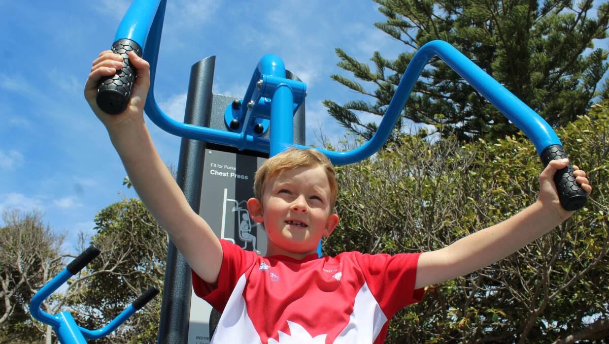 WORKING OUT: Seven-year-old Oxley Smith of Tathra tries out the chest press at the town's newly-opened exercise park. 