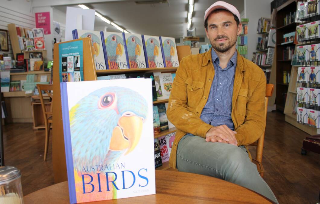 WORK OF ART: Matt Chun takes a break from drawing a cassowary on the window of Candelo Books in Bega to discuss his book Australian Birds. 