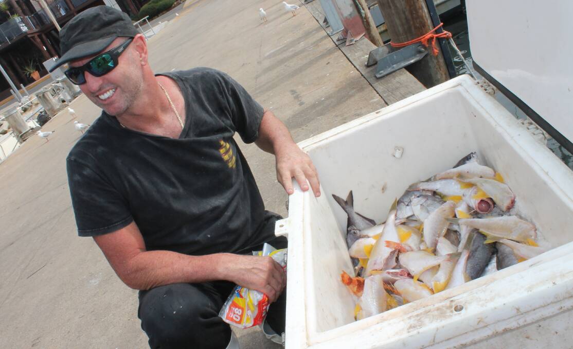 KIND THOUGHT: Jason Moyce, also known as Trapman Bermagui, is down to the last esky filled with fresh fish after his giveaway on Thursday afternoon. Picture: Albert McKnight 