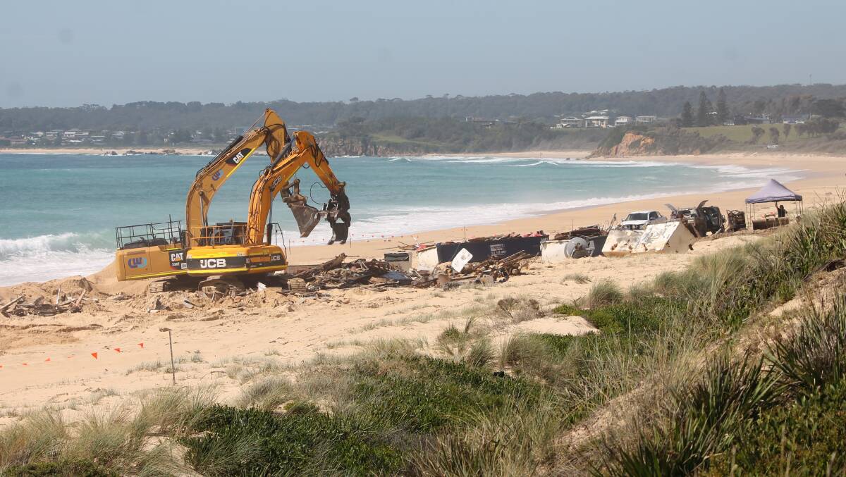 HARD AT WORK: There did not appear to be much of the Salvatore V left on the beach on Thursday morning. 