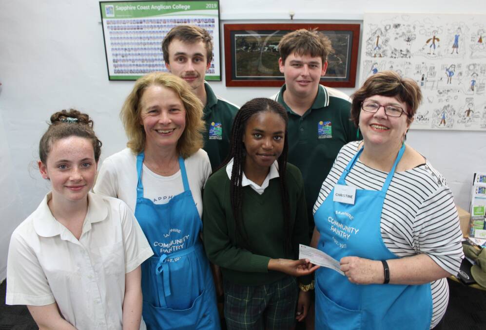 BIG HEARTS: SCAC students Lila Moore, Duncan Weber, Noma Khumalo and Jack Kampman with the Sapphire Community Pantry's Jo Oastler and Christine Welsh. 